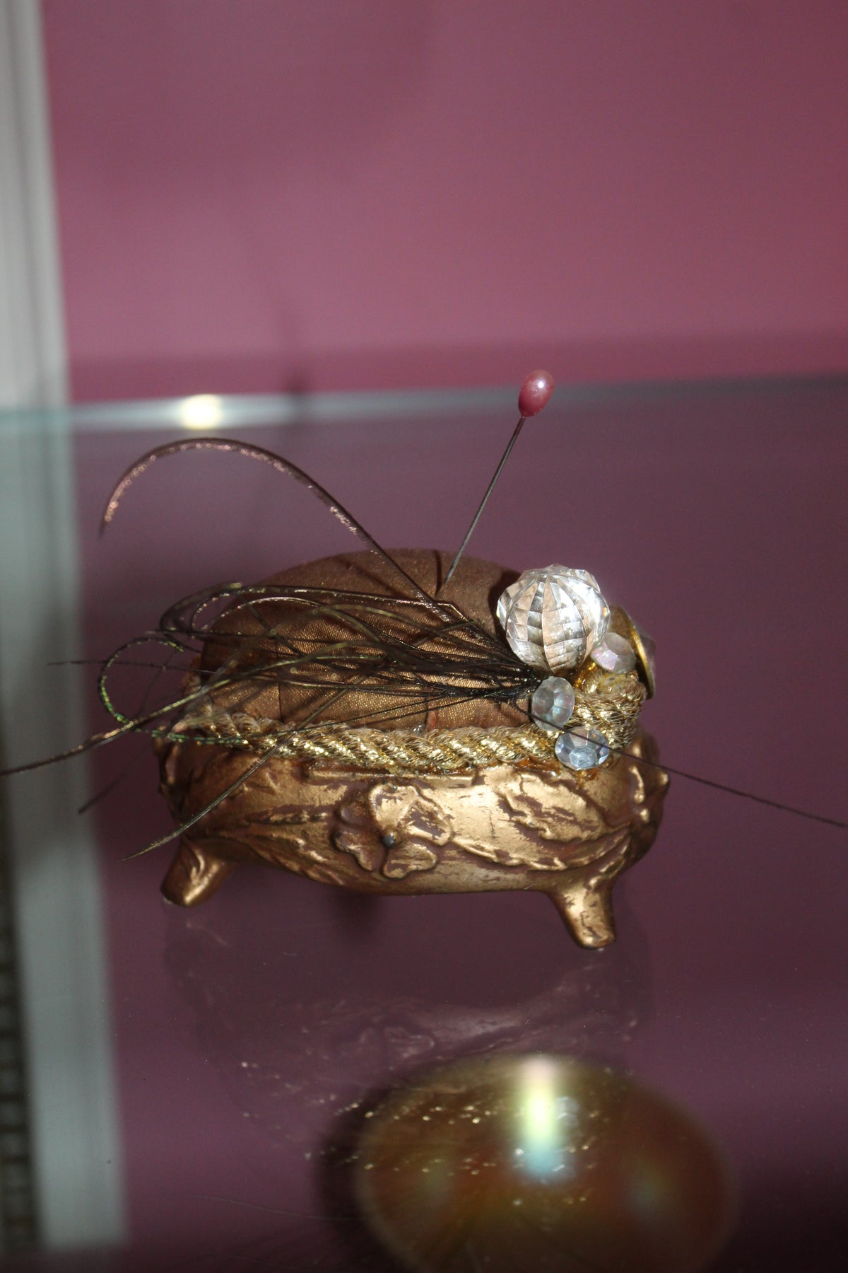 Vintage Gold-Tone Pin Cushion – Ornate Footed Sewing Notion with Feather & Rhinestone Detail