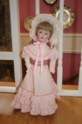 Vintage Porcelain Girl Doll in Pink Ruffled Dress & Lace Bonnet – Collector Doll